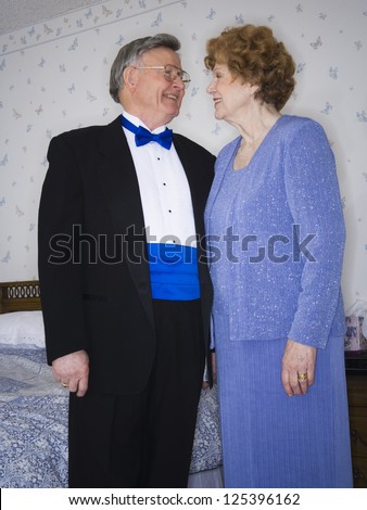 Three quarter length of a senior couple in formal wear