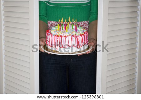 Woman carrying a decorated fancy cake