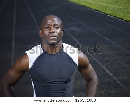 Track runner standing on running track