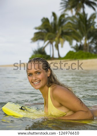 Portrait of a teenage girl on a boogie board