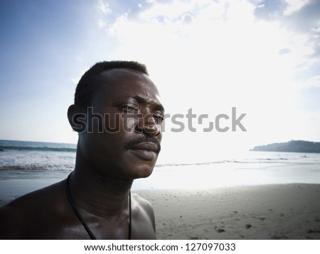 Black male posing for portrait on beach