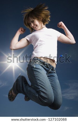 Low angle view of a teenage girl jumping