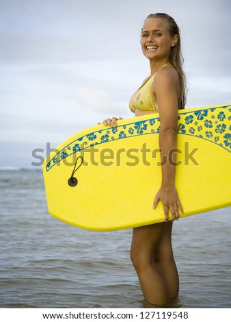 Teenage girl holding a boogie board