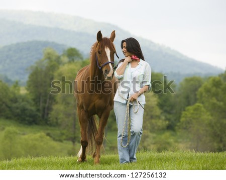 Woman walking with a horse