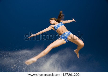 Low angle view of a young woman jumping