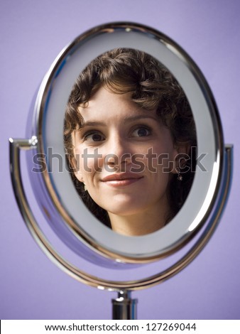 Close-up of a young woman\'s reflection in a mirror