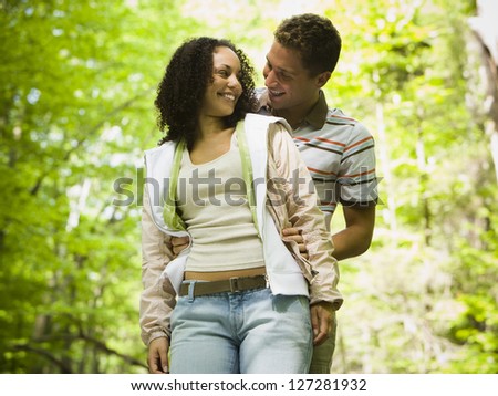 Close-up of a young man embracing a young woman from behind