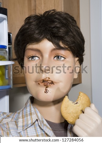 Close-up of a male mannequin holding a cookie - stock photo