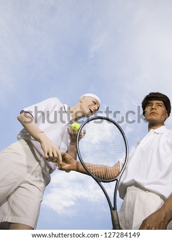 Low angle view of two mannequins portraying tennis players