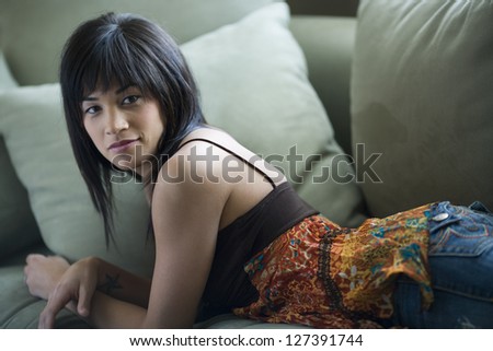 Woman in casual clothing lying on couch