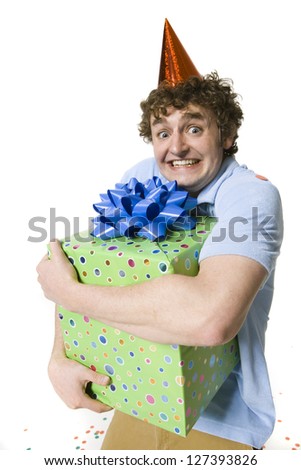 Young man embracing a huge gift box