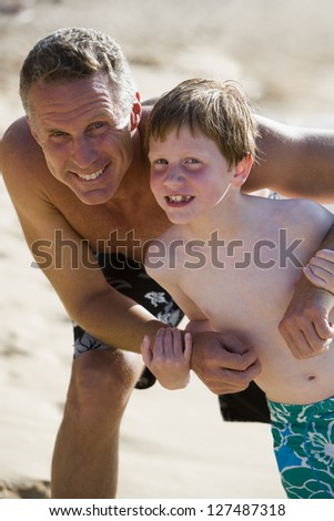 Man and boy outdoors in swimming trunks