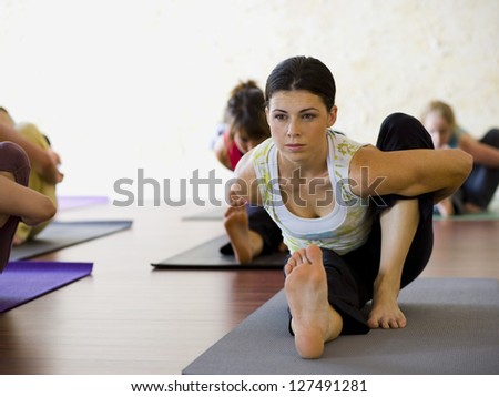 Women at yoga class stretching