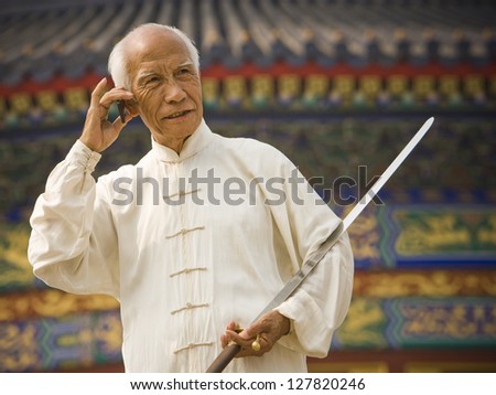 Man with sword talking on cell phone