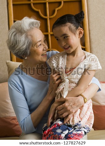 Grandmother with granddaughter smiling
