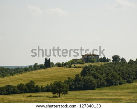 Building on hill with trees and sky