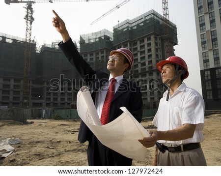 Architect on the job site with a worker.