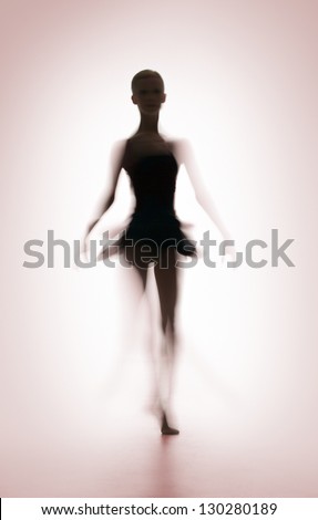 Silhouette of dancing woman on pink background