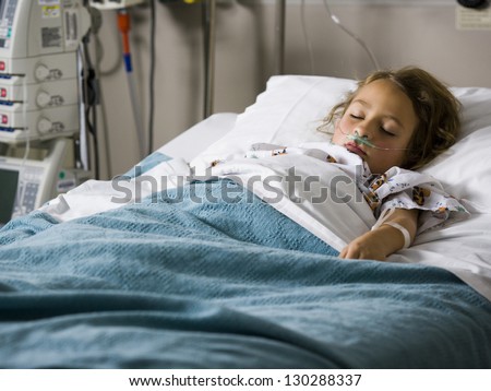 Young girl sleeping in hospital with oxygen tube