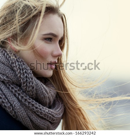Portrait Of Beautiful Girl In Profile Close-Up In The Wind