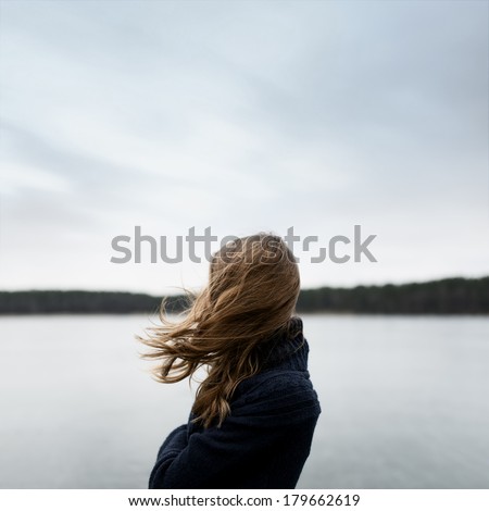 Art portrait of a girl in profile with no face with flying hair