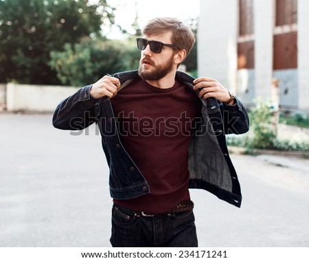 Beautiful brutal man with a beard and glasses