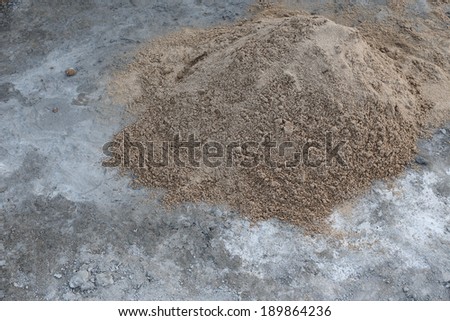 pile sand on cement floor