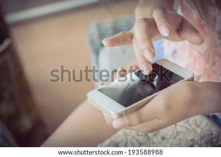 women using a smart phone, hand touch on screen digital mobile, shallow depth of field image vintage tone