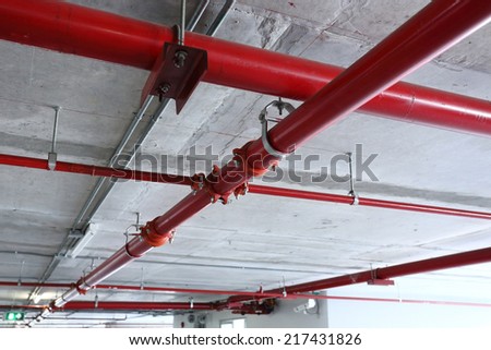 red pipeline extinguishing water in industrial building