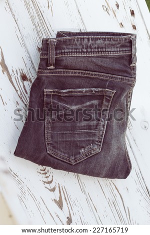 black jeans on white wood, retro tone image