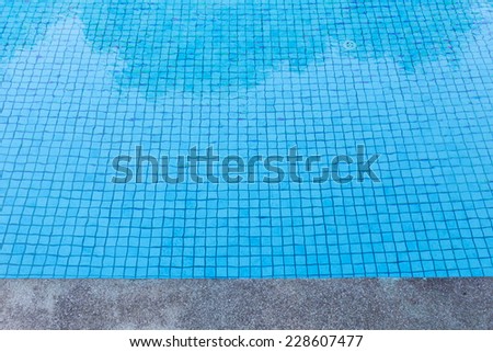 blue tile floor under water of swimming pool texture