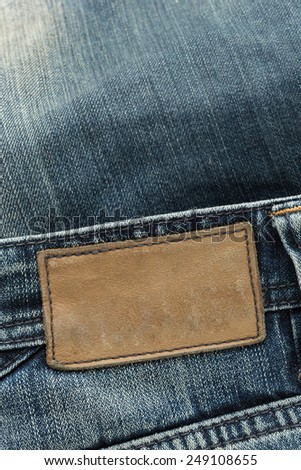 brown leather tag label on blue jeans