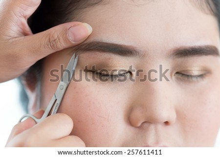 makeup artist used eyebrow scissors makeup a pretty woman face
