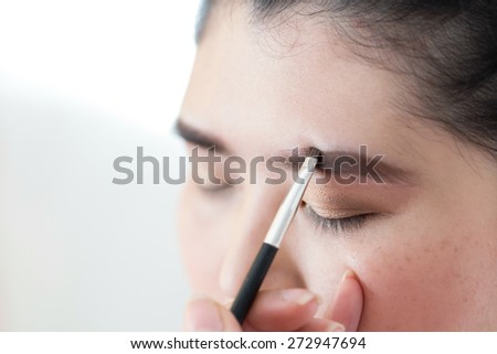 makeup beauty with brush eyebrow on pretty woman