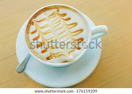 caramel macchiato hot of coffee drink on wooden table in the cafe