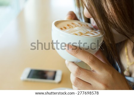 beautiful girl drinking hot coffee or tea in coffee cafe, model asia women, female of thai people