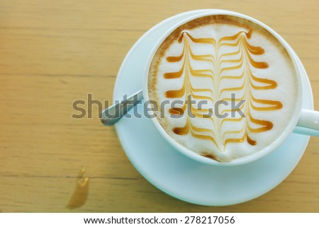 caramel macchiato hot of coffee drink on wooden table in the cafe