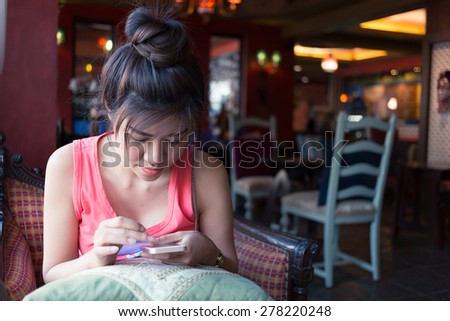 women lifestyle using a mobile phone in cafe coffee shop with texting message on app smartphone playing social network