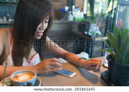 lifestyle of women using a mobile phone in cafe coffee shop with texting message on app smartphone playing social network