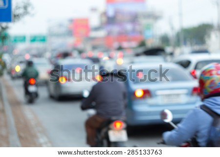 car and motorcycle driving on road with traffic jam in the city, abstract blurred background