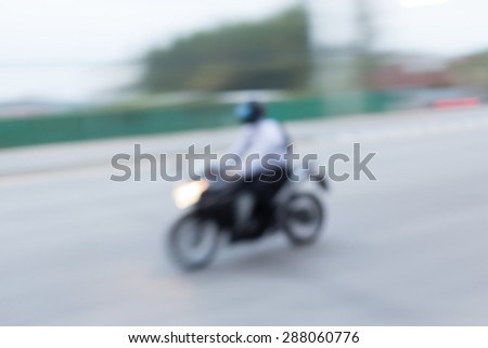 motorcycle driving on road, abstract blurred background