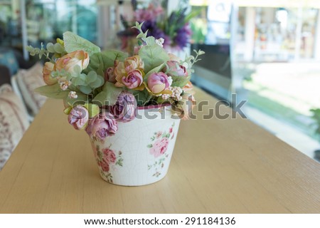 flowers vase decoupage decorated on wooden table at living room, artificial flowers in vase
