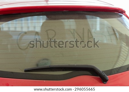 text of car wash on back mirror dirty car