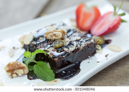 cake chocolate with strawberry and bananas on white plate