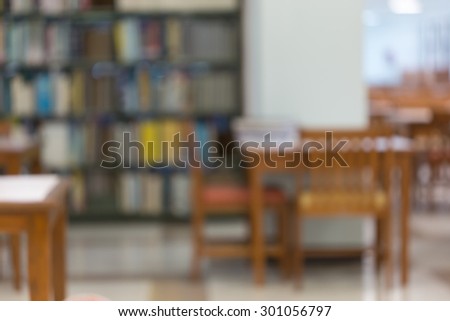 bookshelf and table desk in library, education abstract blur defocused background
