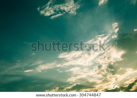 light of sunbeam on blue sky background with clouds, image used filter vintage