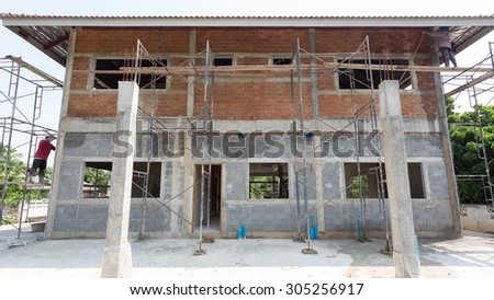 building residential construction house with scaffold steel for construction worker, wall made from brick