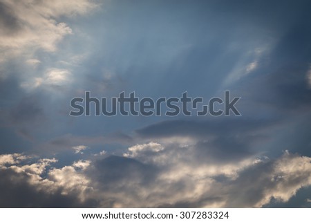 light of sunbeam on blue sky background with clouds and sun light