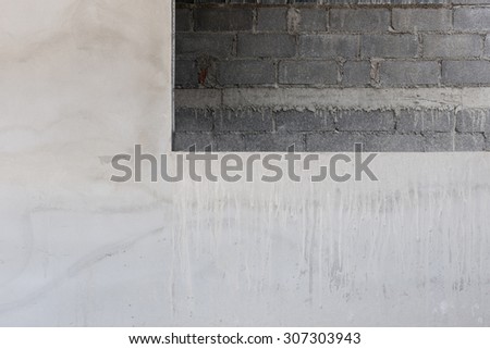 window on cement wall with brick wall background in construction building