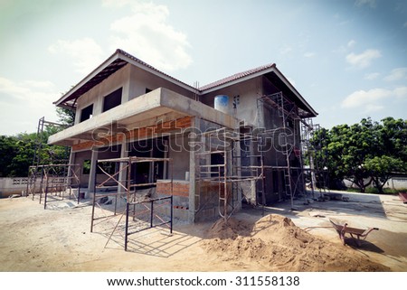 building residential construction house with scaffold steel for construction worker, image used vintage filter